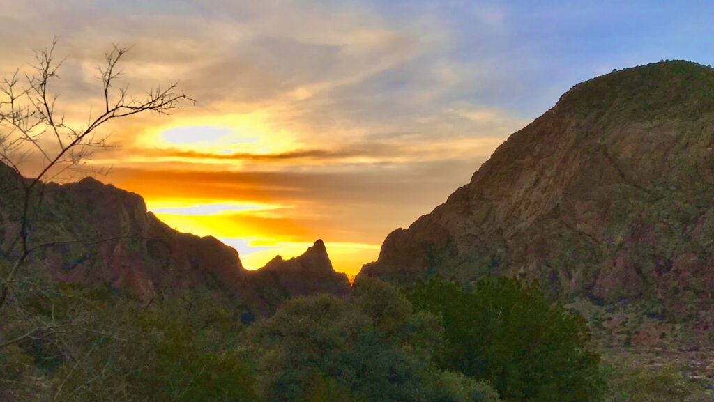 Sunset view through the Window in Big Bend National Park, with glowing sky framed by canyon walls.