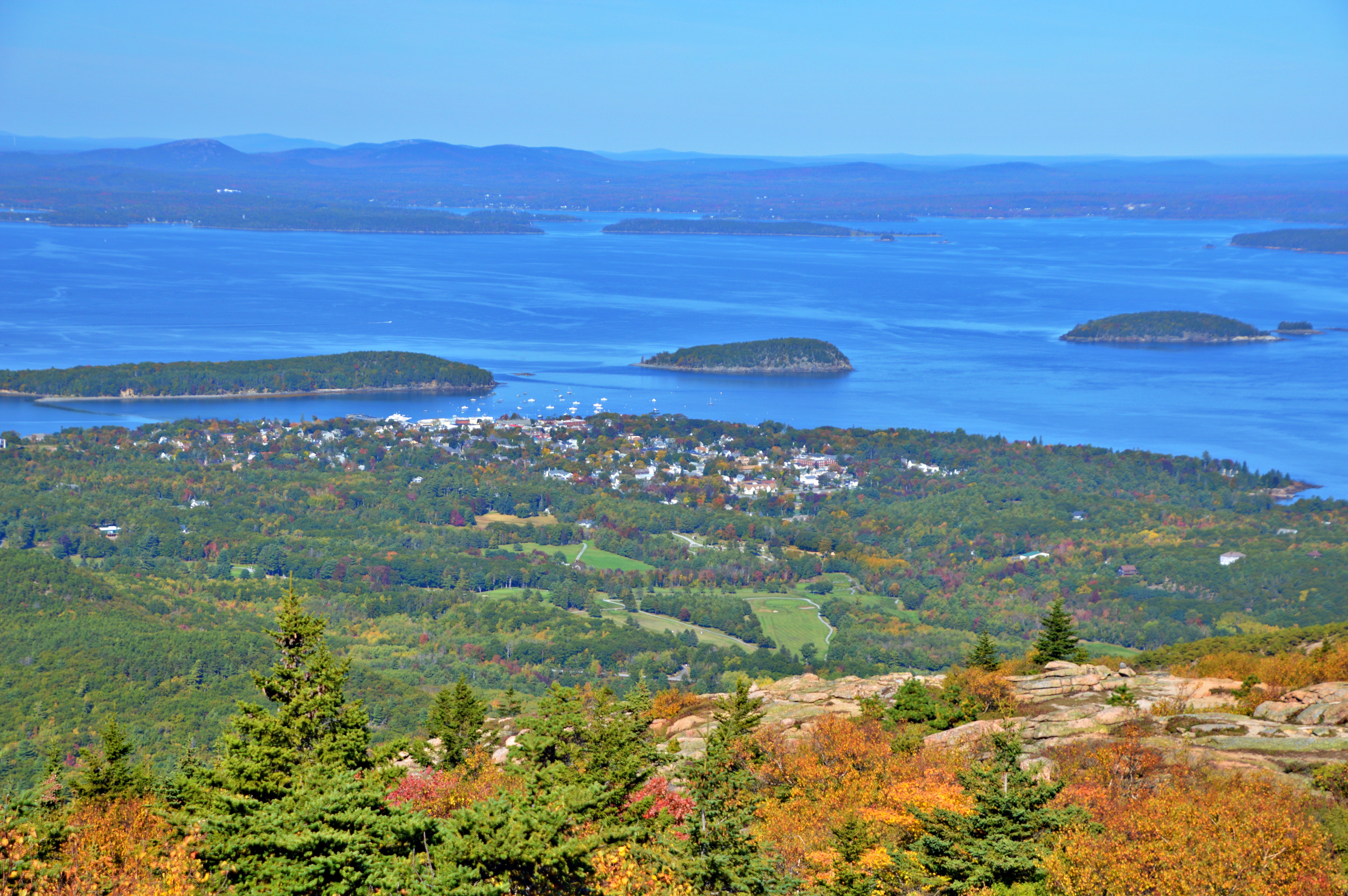 Autumn foliage and coastal views seen from the summit of Cadillac Mountain in Acadia National Park