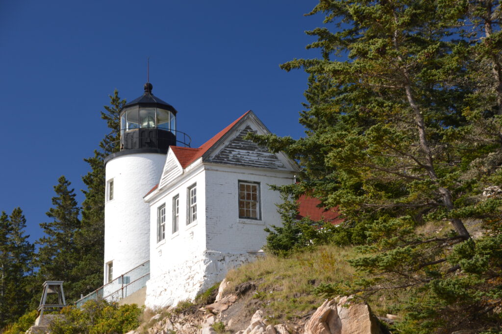 Bass Harbor Head Lighthouse on a rocky cliff in Acadia National Park