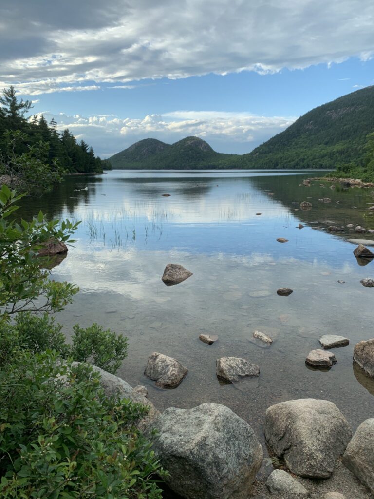 Jordan Pond at dusk in Acadia National Park, with the Bubbles mountains reflected in calm water