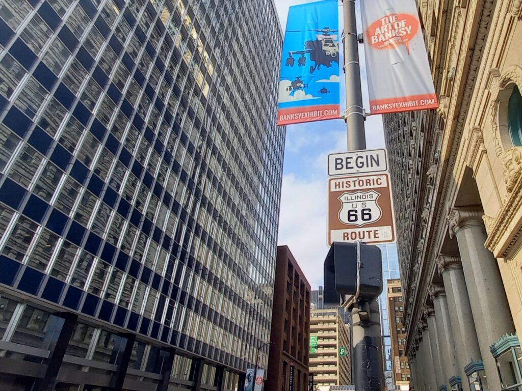 The Begin Historic Route 66 sign in downtown Chicago, marking the start of the Mother Road at Adams Street