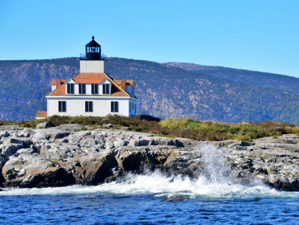 Egg Rock Lighthouse on a rocky outcrop with waves crashing in Frenchman Bay, Acadia National Park