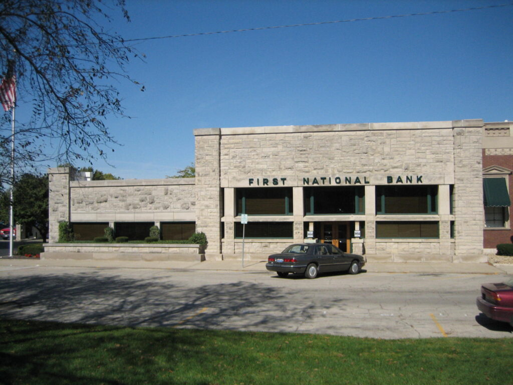 The First National Bank of Dwight, a low limestone building with the bank's name carved above the entrance, designed by Frank Lloyd Wright