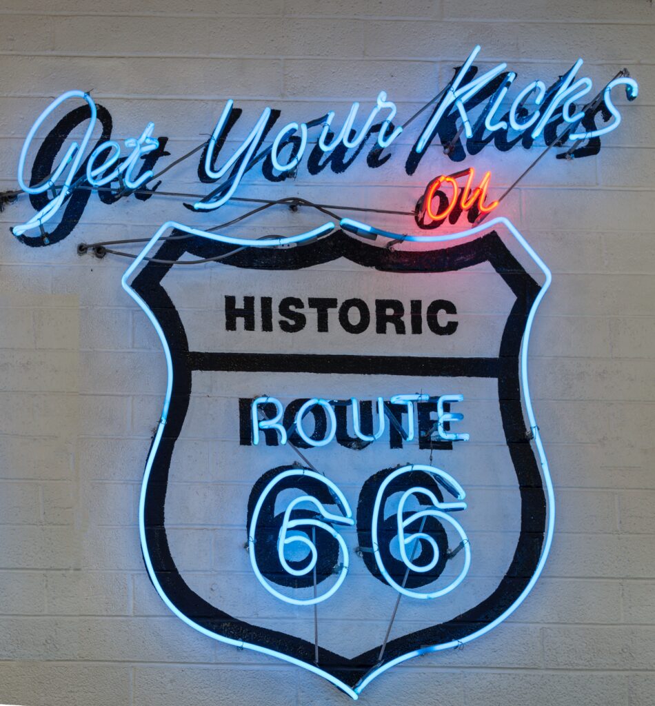 A neon sign reading "Get Your Kicks on Historic Route 66" mounted on a brick wall in Amarillo, Texas