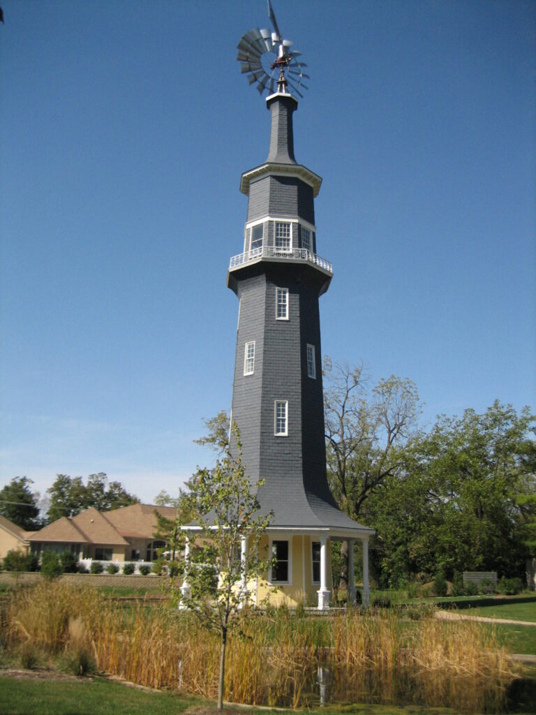 he historic eight-sided Dwight windmill in Illinois, built in 1896 on the Oughton Estate, with its metal windmill head against a blue sky