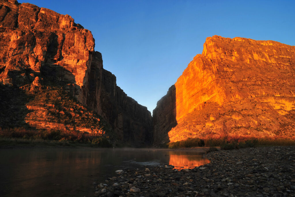 Golden sunset light illuminates the towering canyon walls of Santa Elena Canyon above the Rio Grande in Big Bend National Park. (NPS Photo/Mark Schuler)