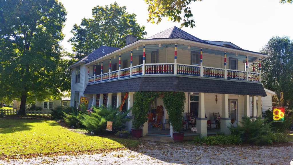 Historic Ozark Country Inn bed and breakfast, built in 1906, with a colorful wraparound porch in Mountain View, Arkansas