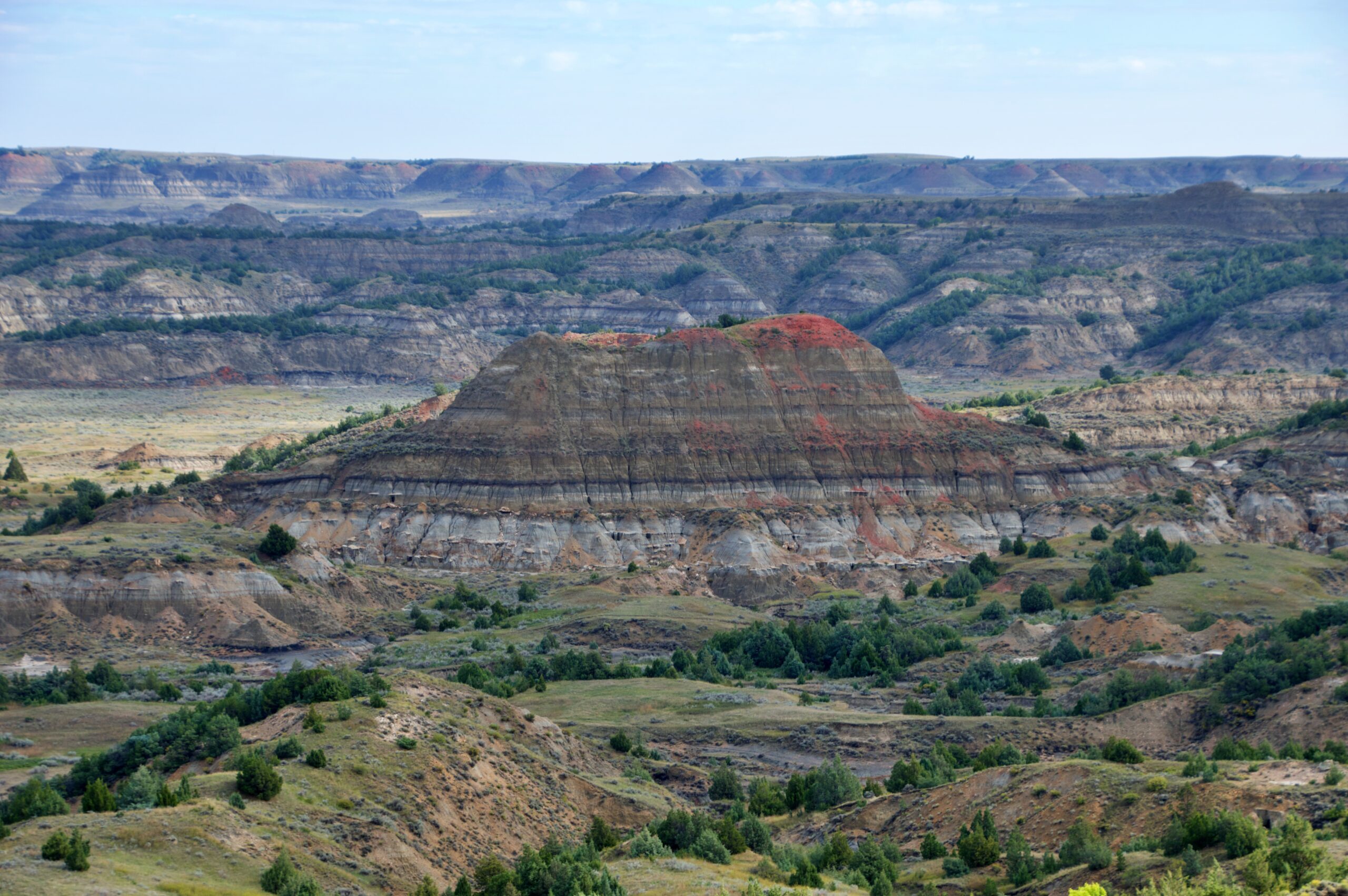 Red and gray striped badlands butte at Painted Canyon Overlook in Theodore Roosevelt National Park's South Unit
