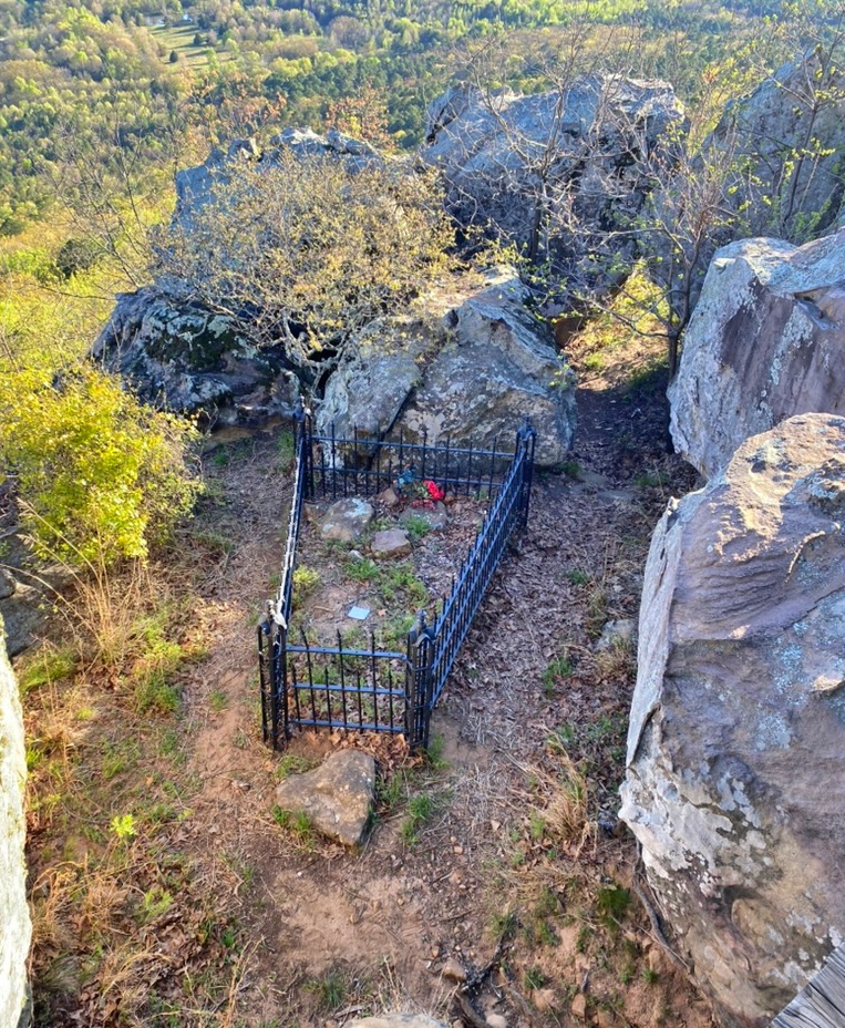 Petit Jean's iron-fenced grave on a rocky bluff overlooking the river valley at Petit Jean State Park, Arkansas
