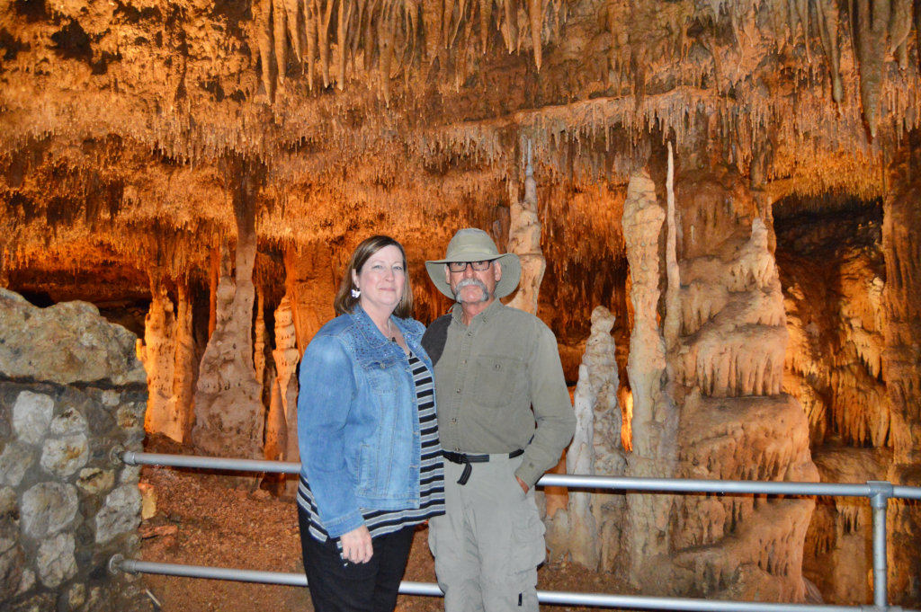 Couple standing beneath hundreds of soda straw stalactite formations in the Soda Straw Room at Blanchard Springs Caverns
